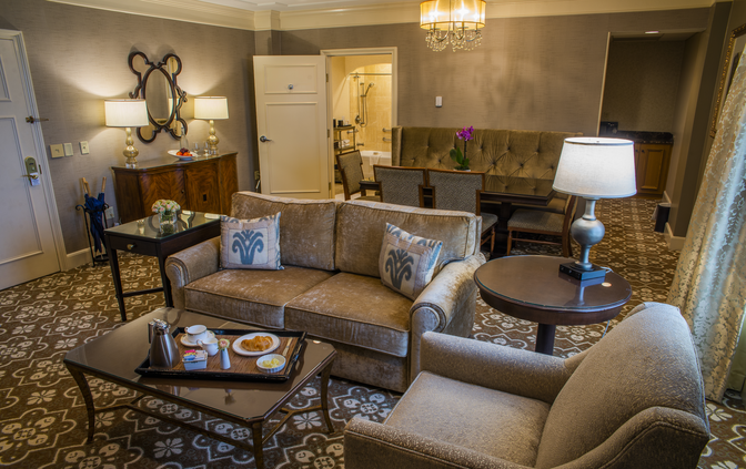 Living room and dining area located at the entrance of a typical suite at The Hotel Hershey.