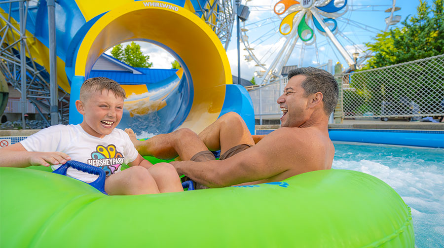 Father and son laughing at waterpark