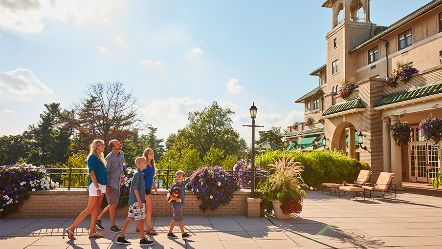 Family admiring the views of Hershey, PA from the veranda located off of the Fountain Lobby at The Hotel Hershey.