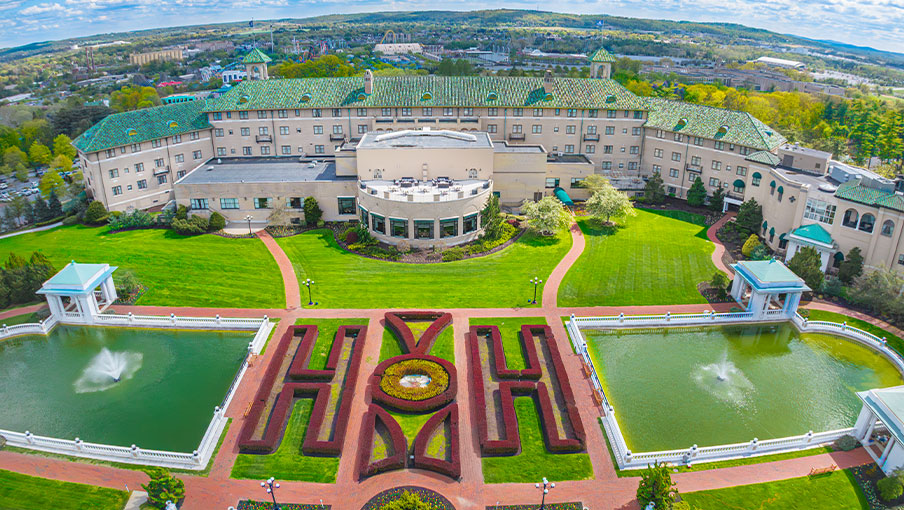 Family admiring the views of Hershey, PA from the veranda located off of the Fountain Lobby at The Hotel Hershey.