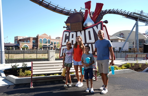 Family in front of candymonium sign