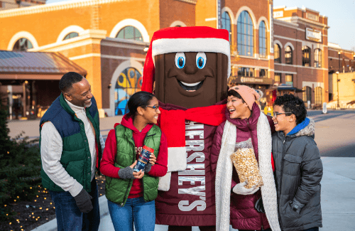 Family enjoying Hersheypark with Hershey's character