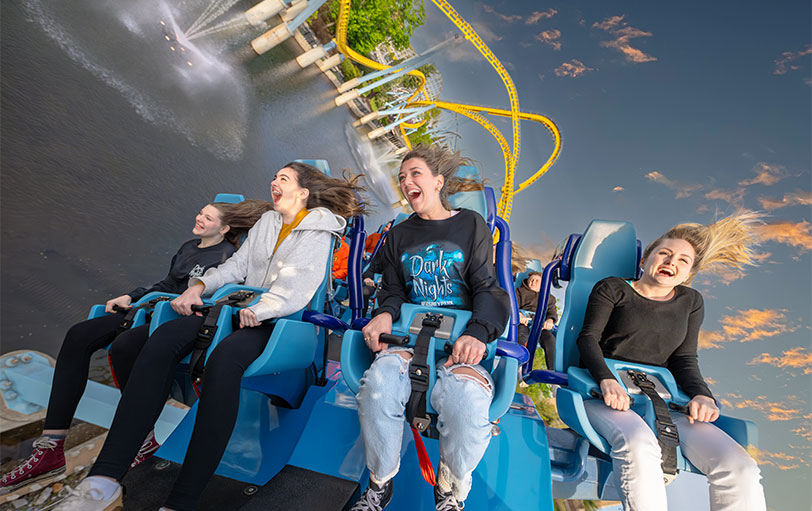 Happy park vistors riding Great Bear with halloween tshirts on
