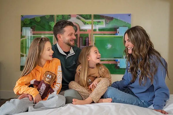Family on bed at Hotel Hershey.